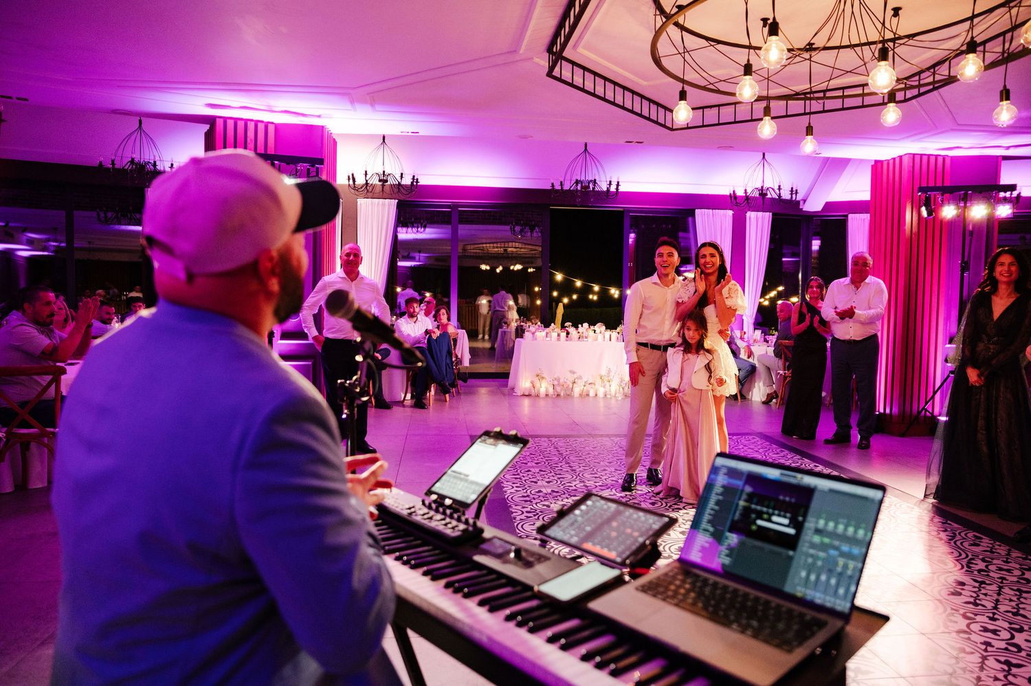 Wedding venue illuminated with purple ambient lighting during evening reception.