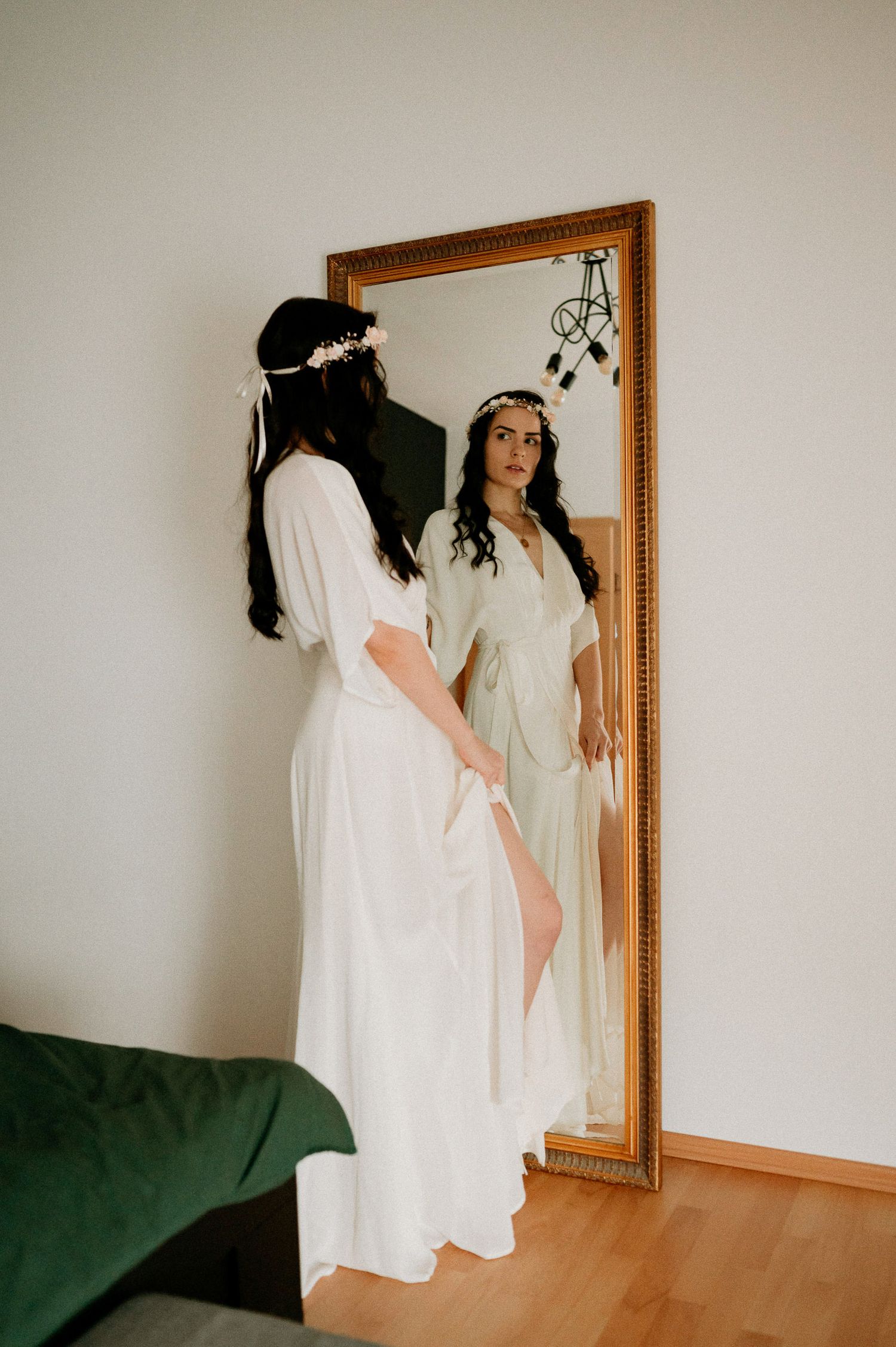 Artistic mirror shots in flowing white dress against minimal interior setting.