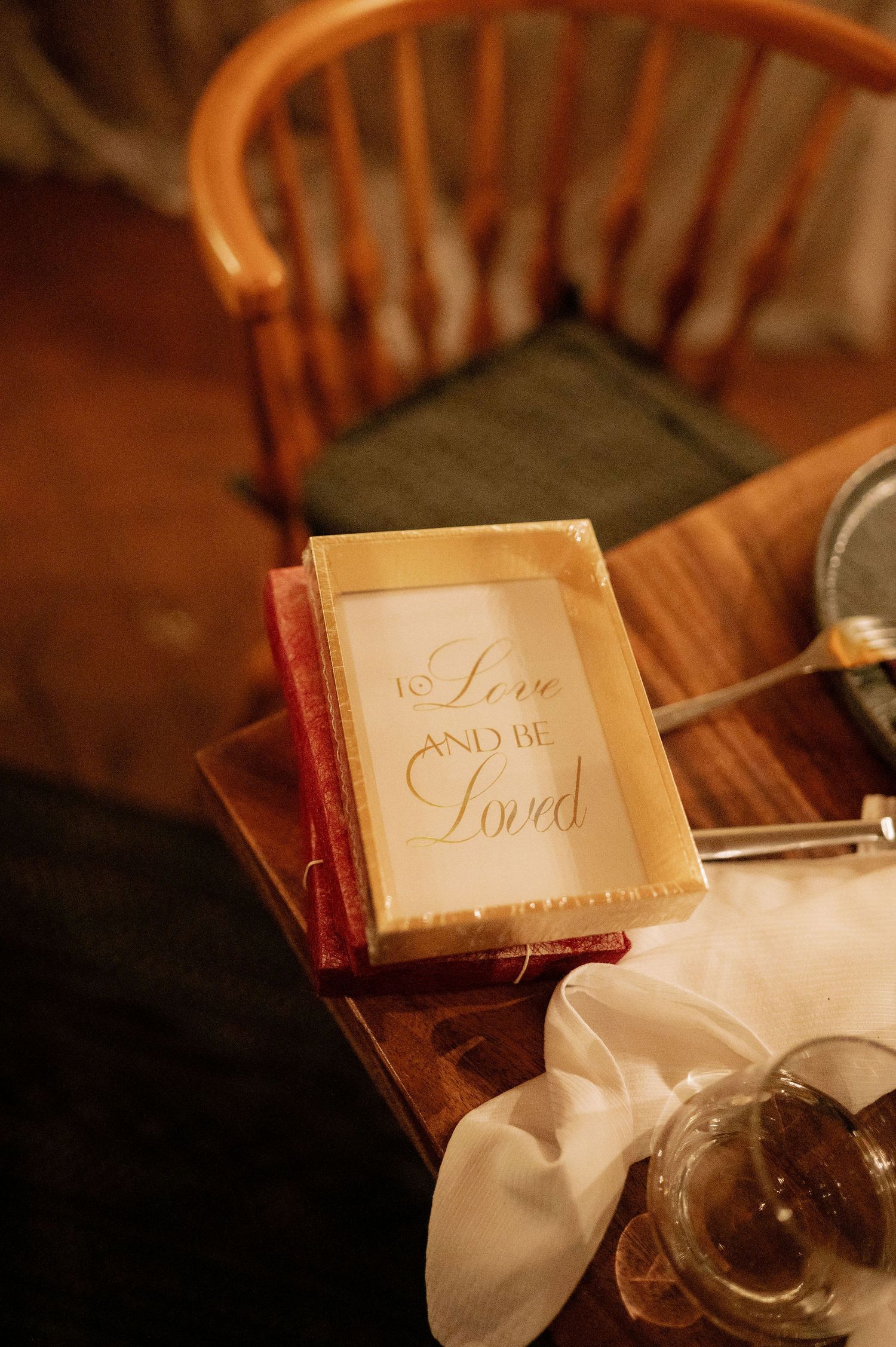 Close-up of elegant wedding reception table details with decorative book and place settings.