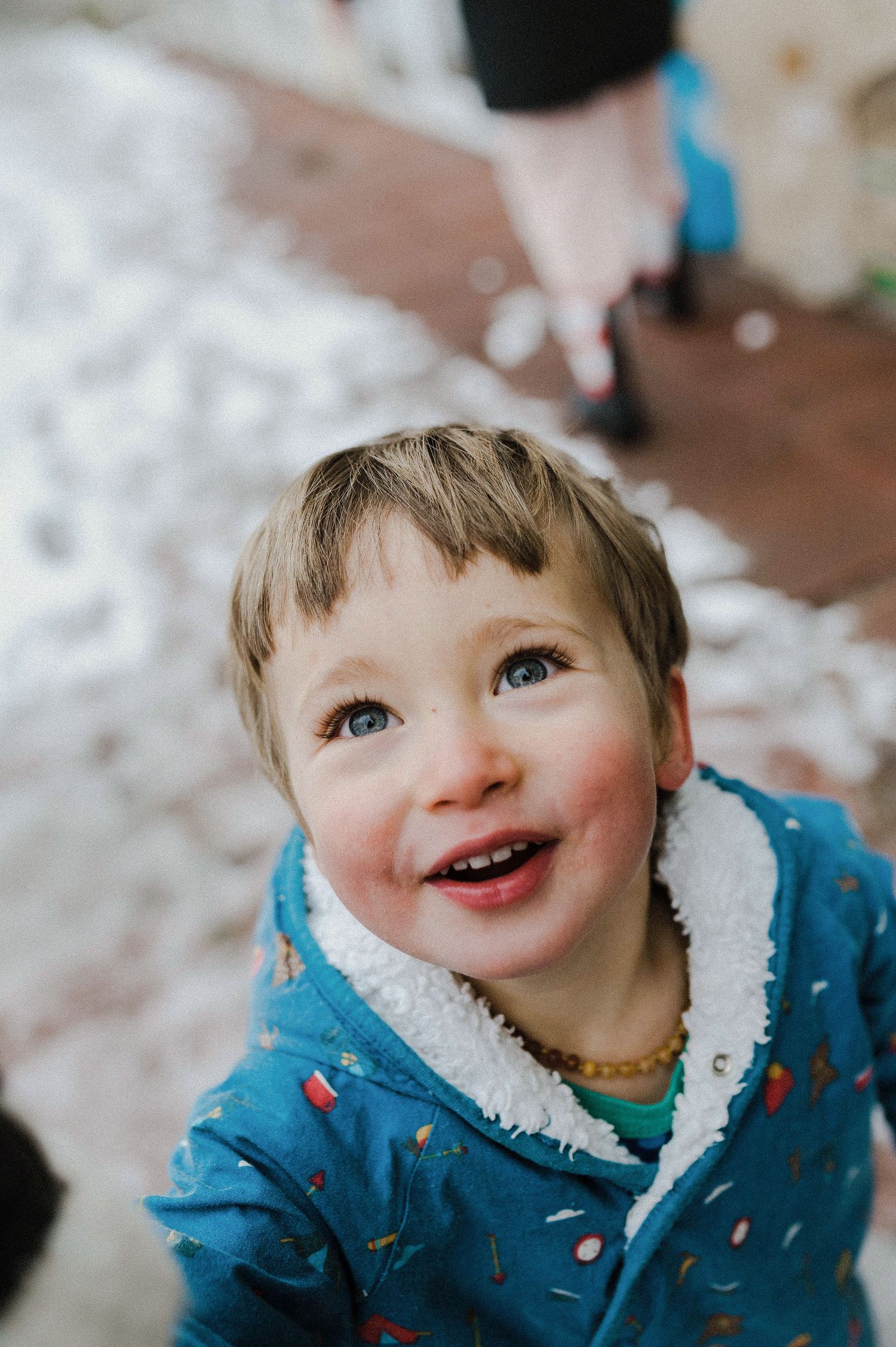 A series of close-up shots showing joyful expressions while wearing a blue winter coat with white trim.