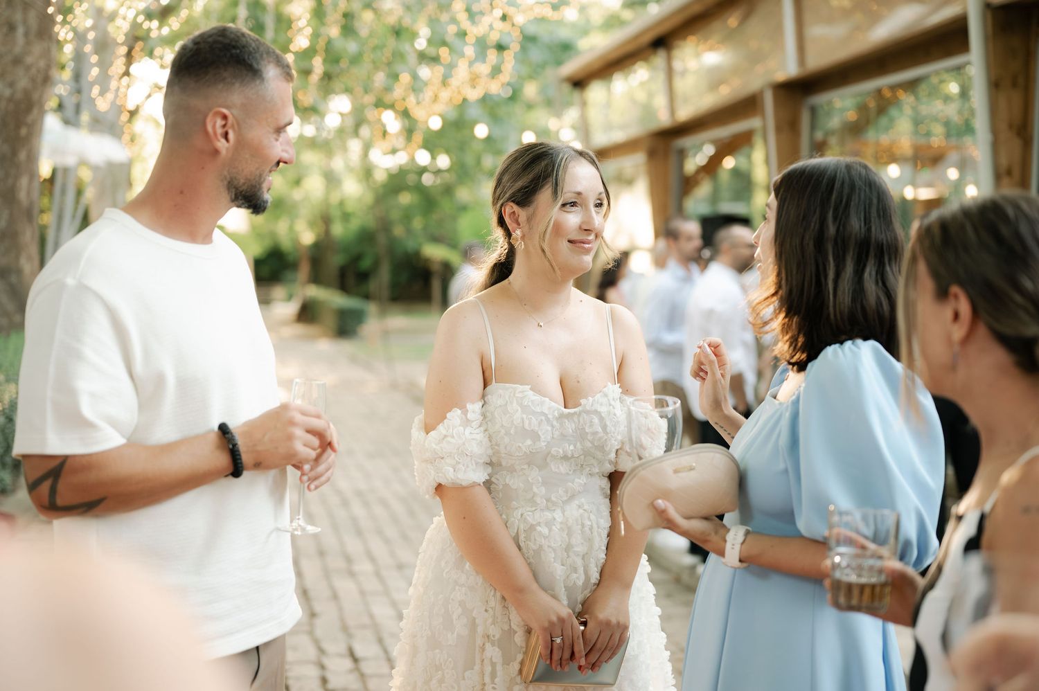 Guests mingling and celebrating at an elegant outdoor garden wedding reception.