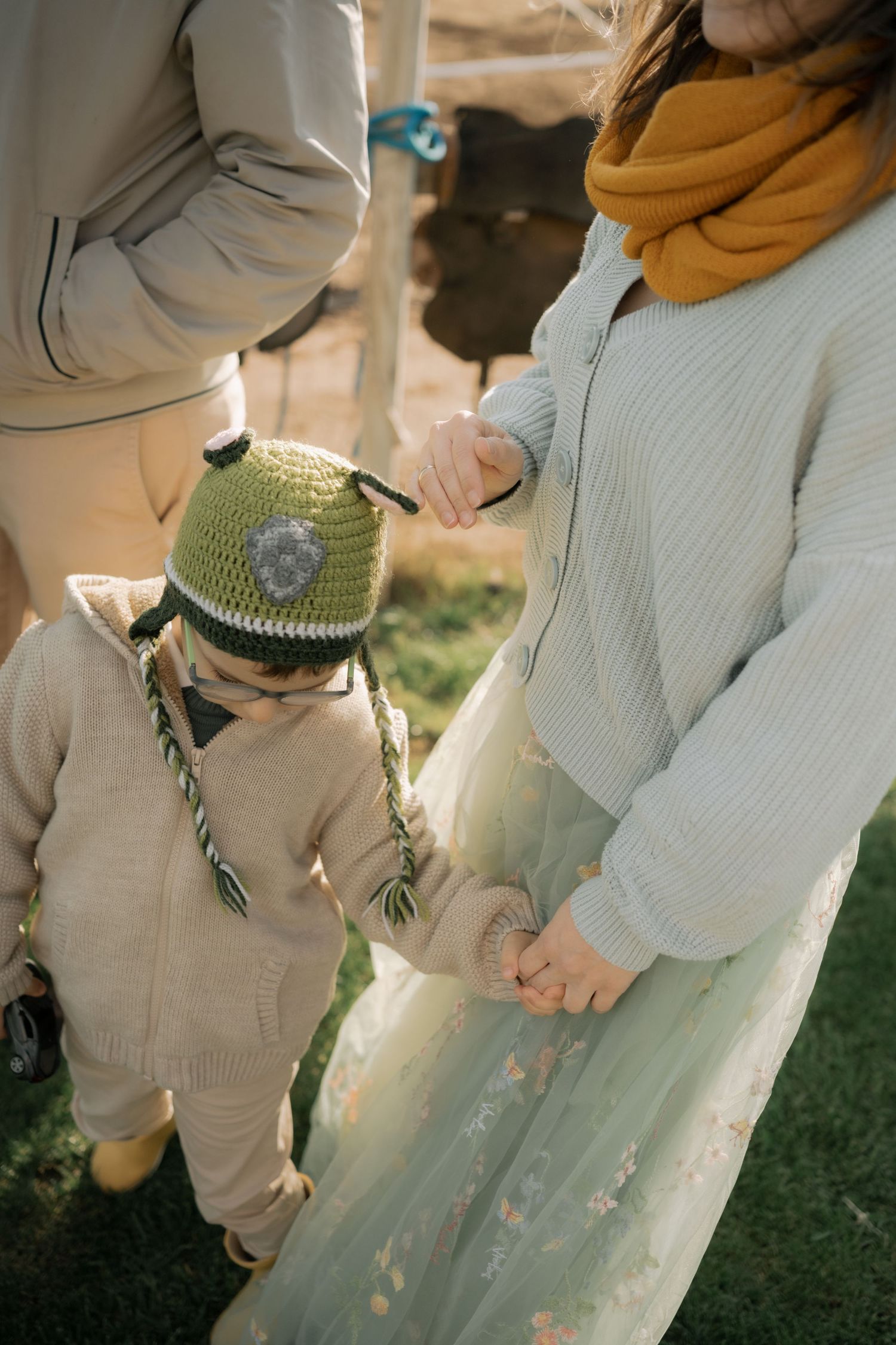 Close-up sequence of hands holding a mason jar with a sparkly glass effect in natural outdoor lighting.