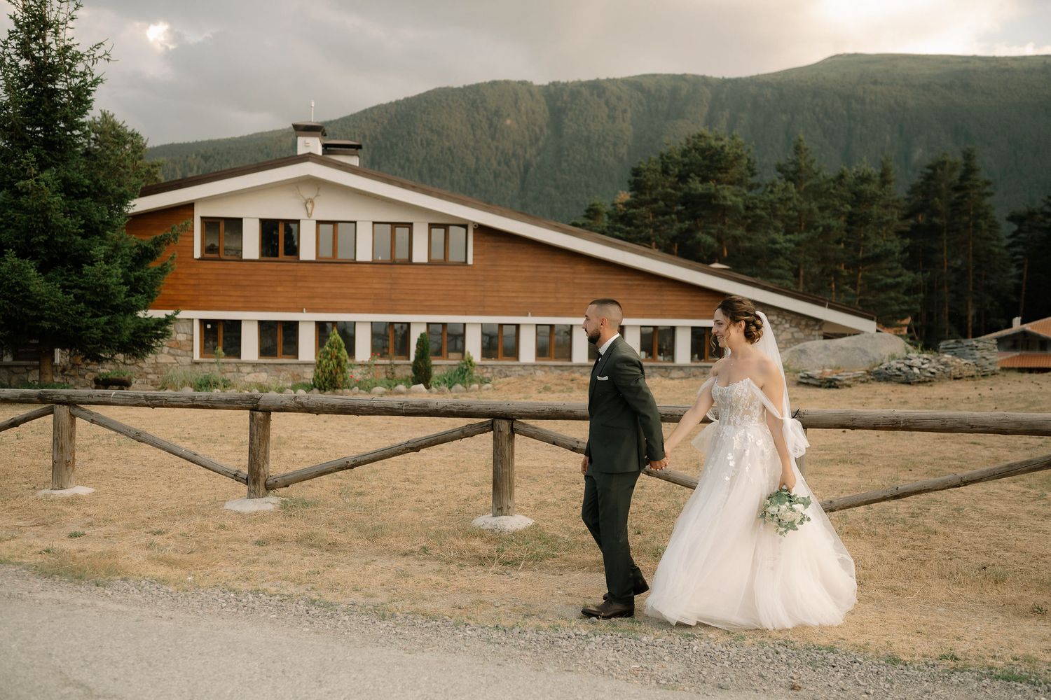 Multiple shots of a wedding couple sharing intimate moments against a wooden fence with mountains in the distance.