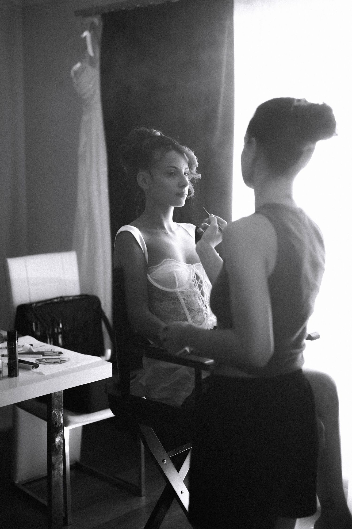 A series of black and white photographs showing silhouettes of people seated in a row against bright windows.