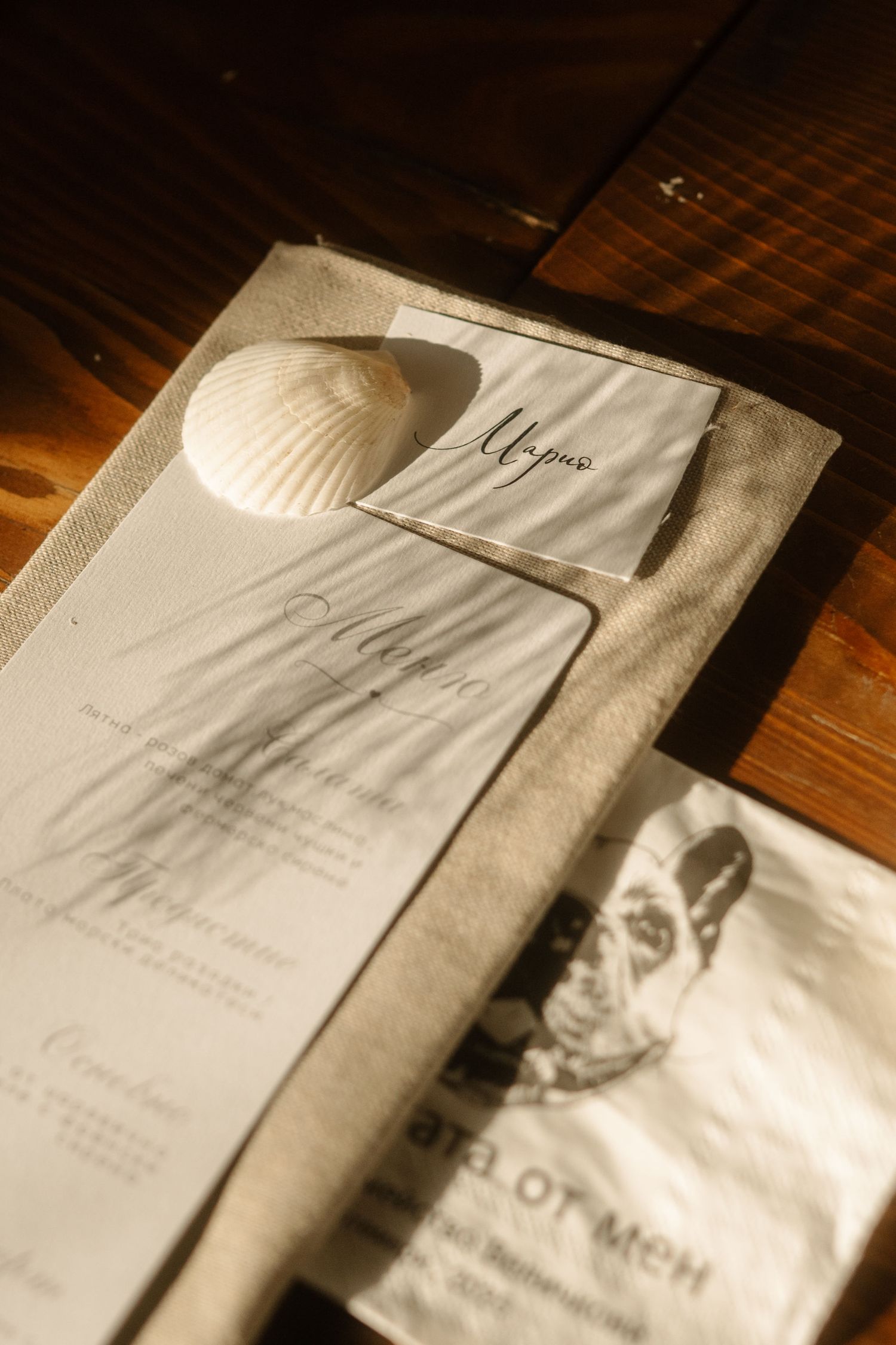 A series of white paper napkins with text printed on them arranged in a row on a dark wooden surface.