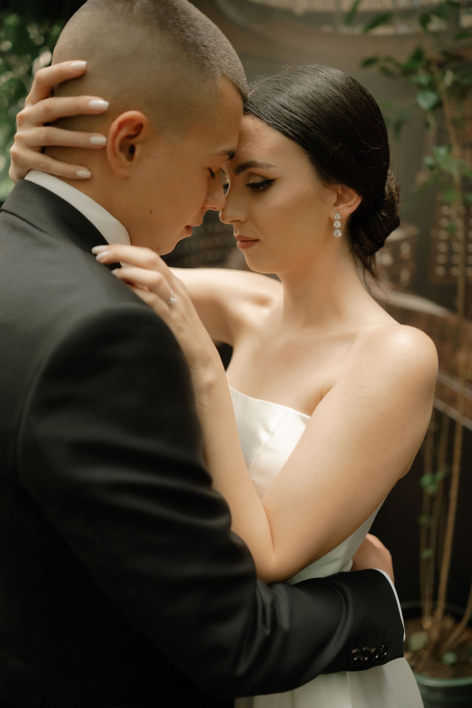 A romantic series of intimate wedding photos showing a couple in formal attire sharing tender moments together outdoors.