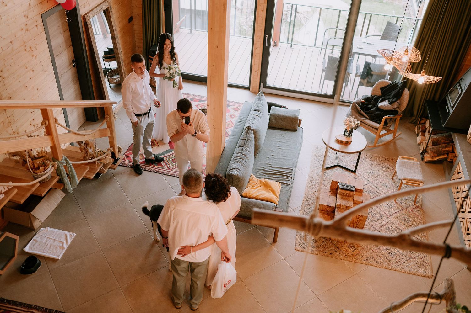 Rustic wedding venue space decorated with string lights and natural elements seen from above.