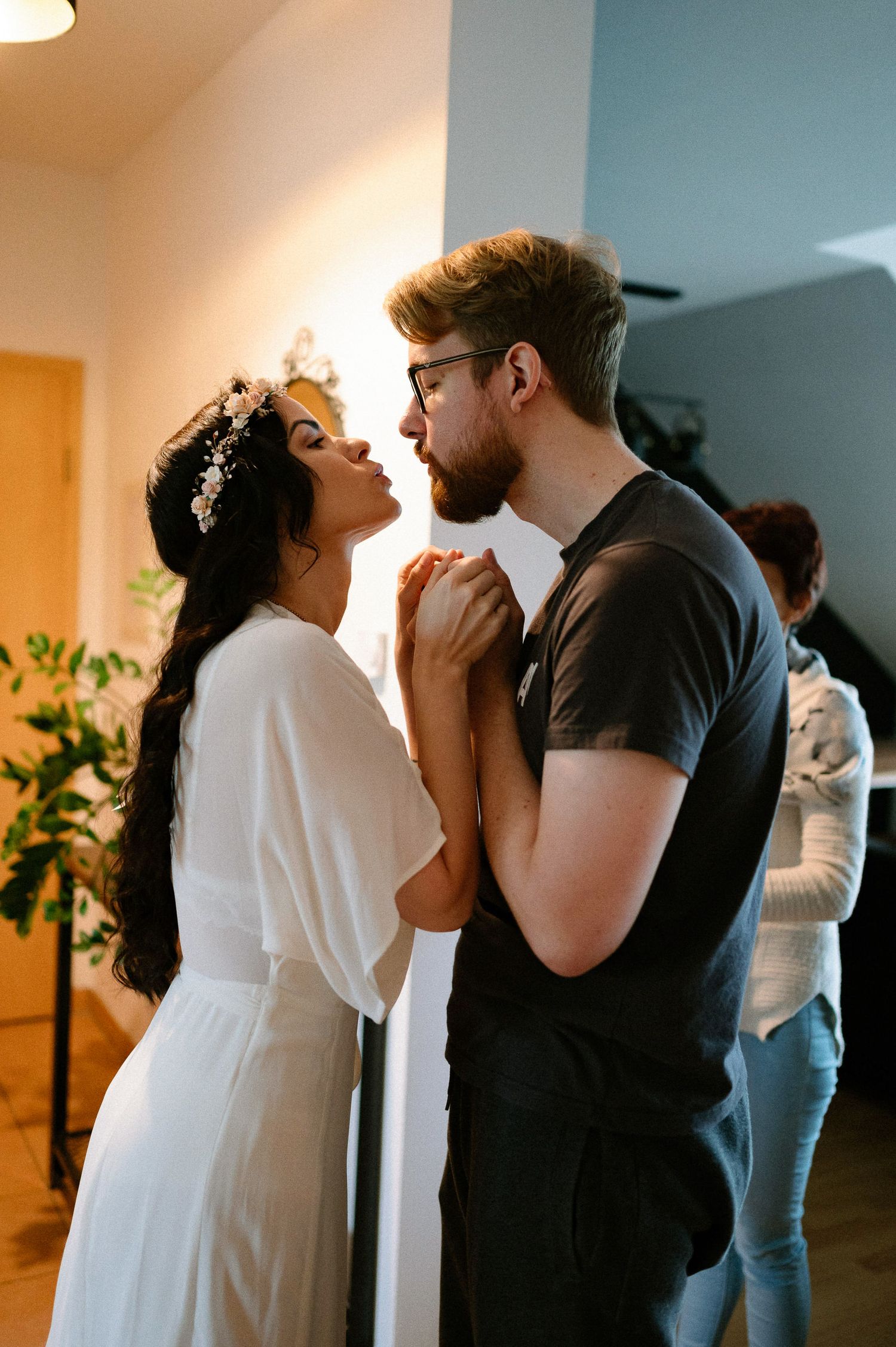 Intimate dance sequence between two people in contrasting white and dark outfits.