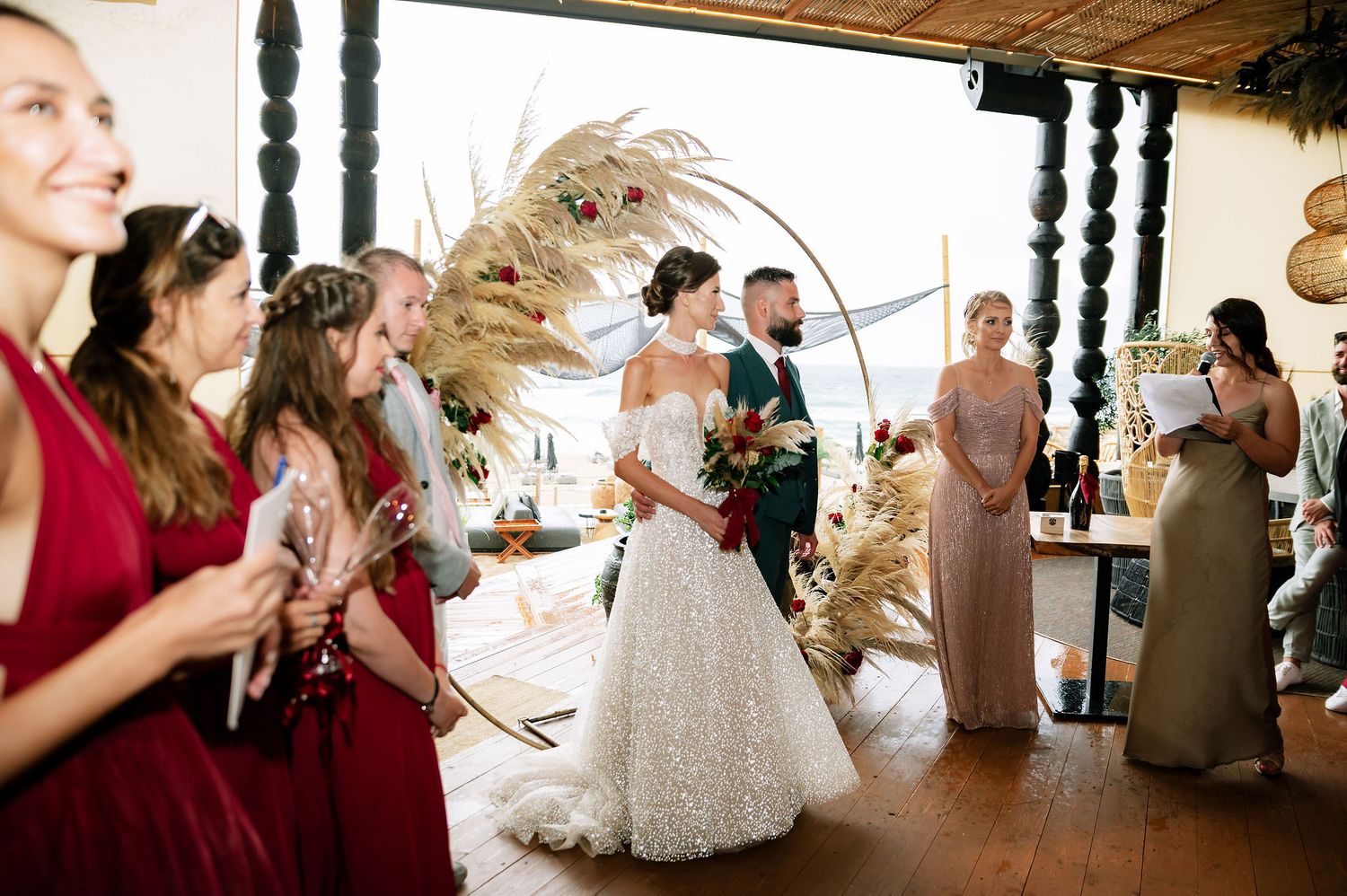 Wedding celebration candid moments captured in a modern venue with natural decor elements.