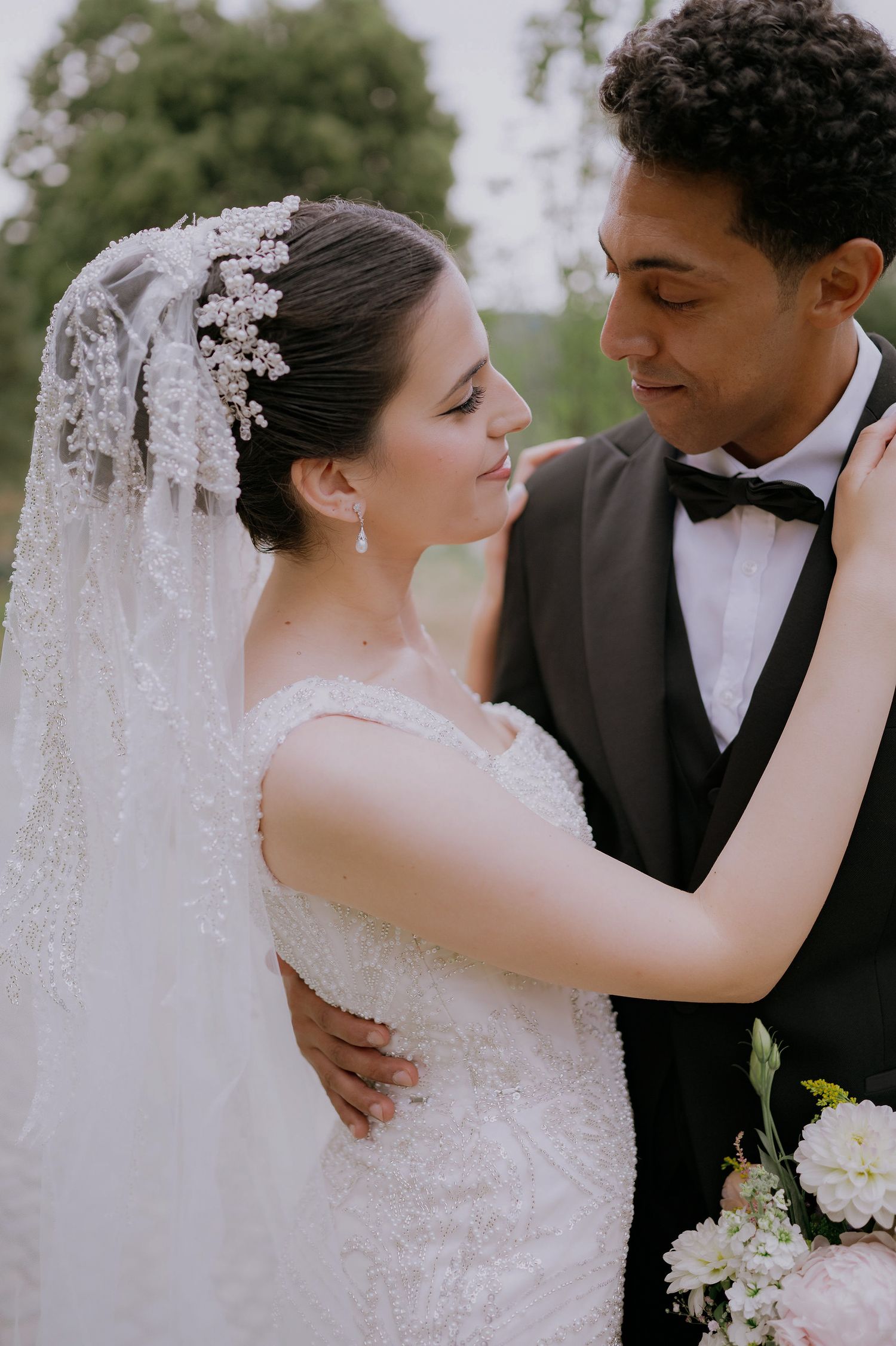 Romantic wedding portrait featuring lace details and intimate embrace.