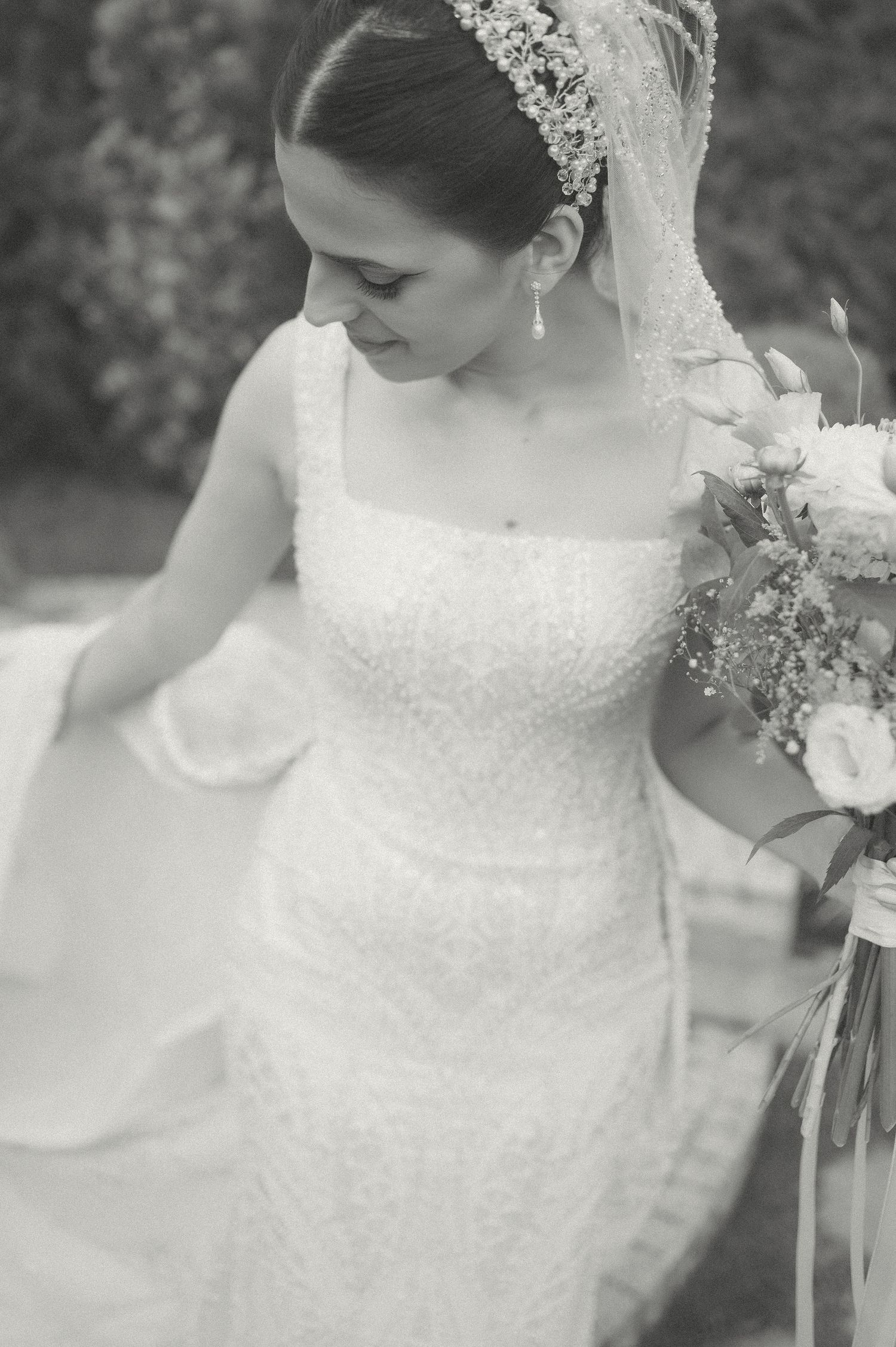 Delicate black and white bridal portrait highlighting lace details and classic styling.