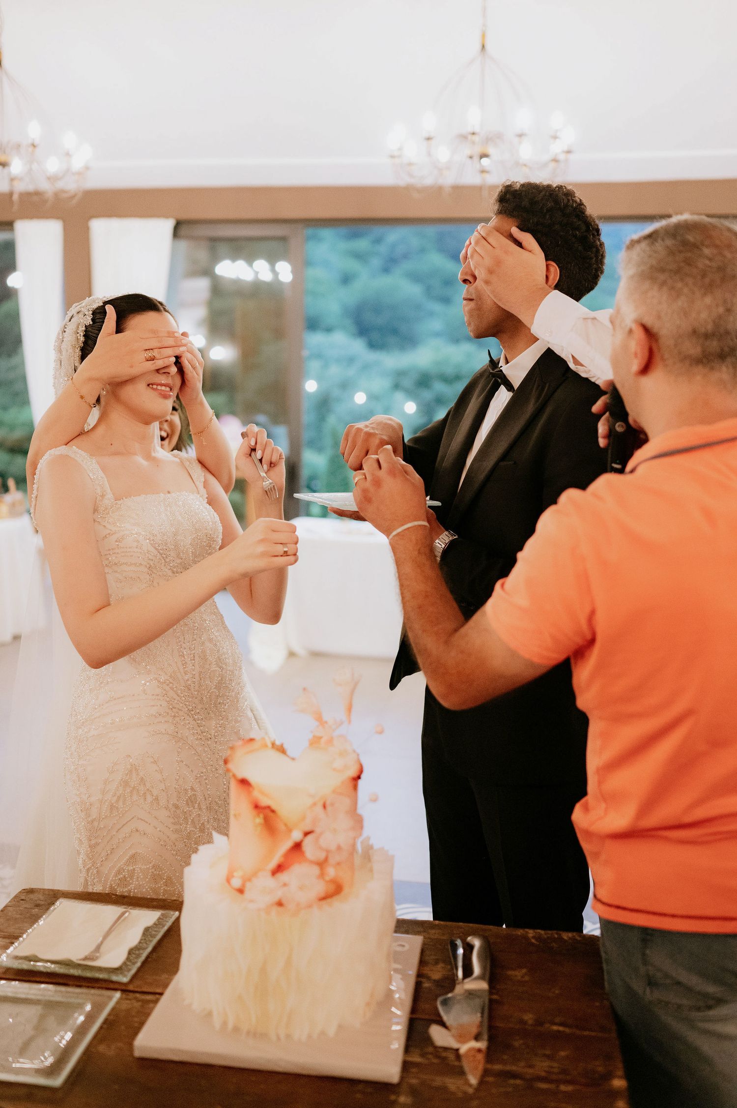 Wedding couple participates in a fun cake tasting game during their reception.