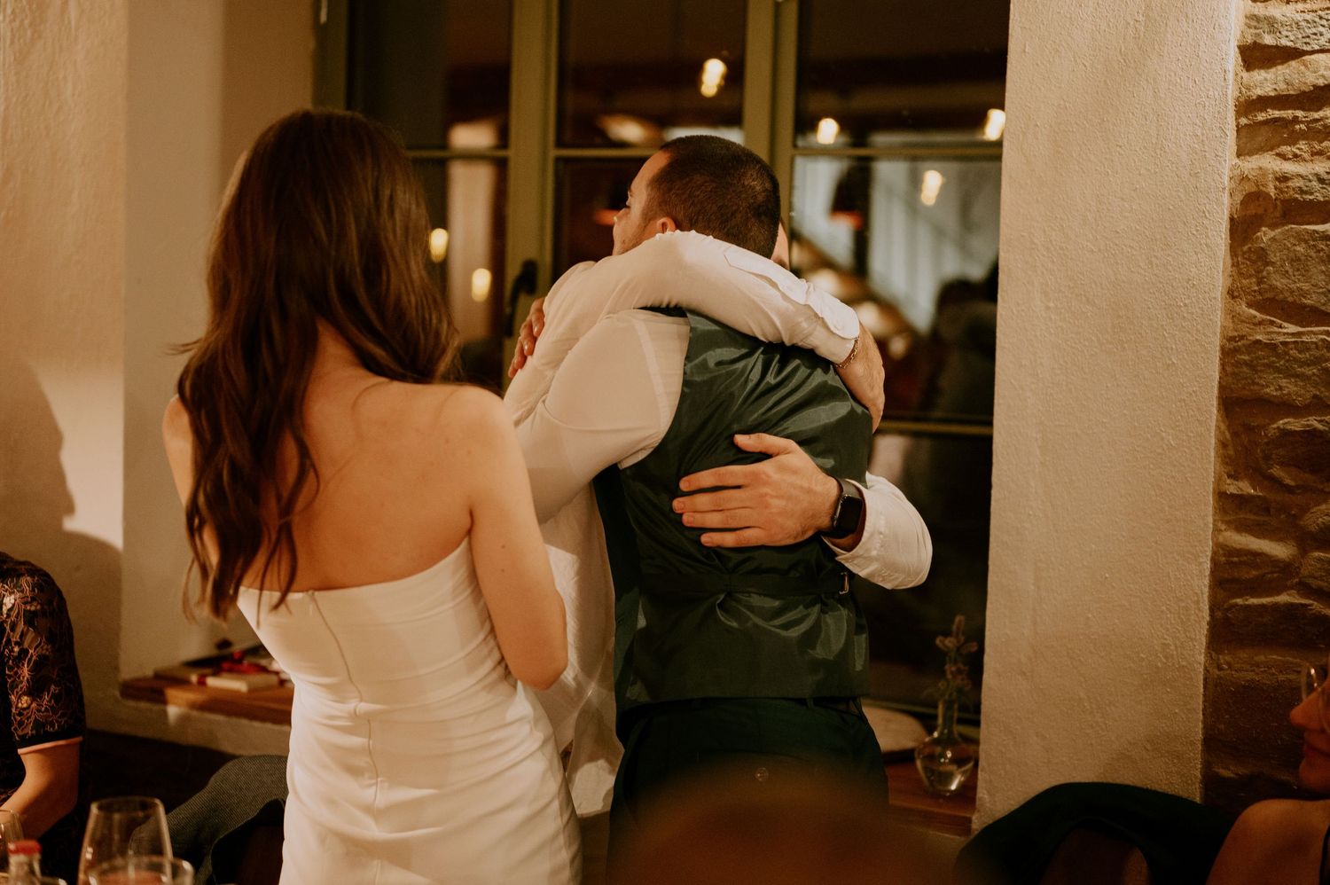 Intimate dance moves captured during a wedding celebration in a cozy indoor setting.