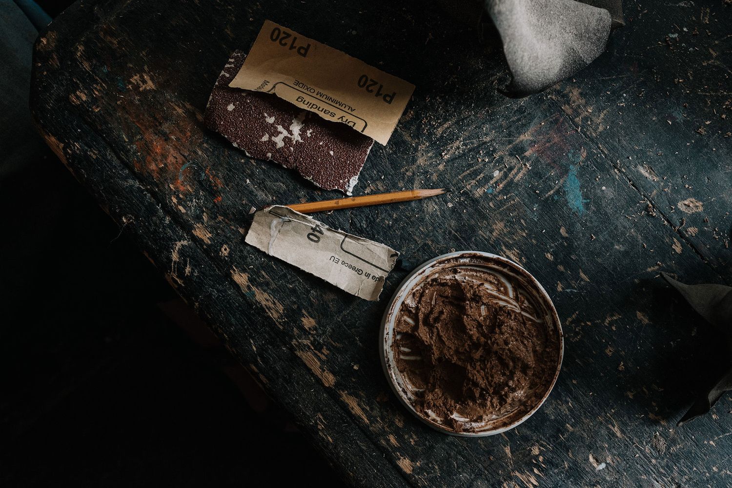 Dark textured surface with scattered vintage items and rustic bowls.
