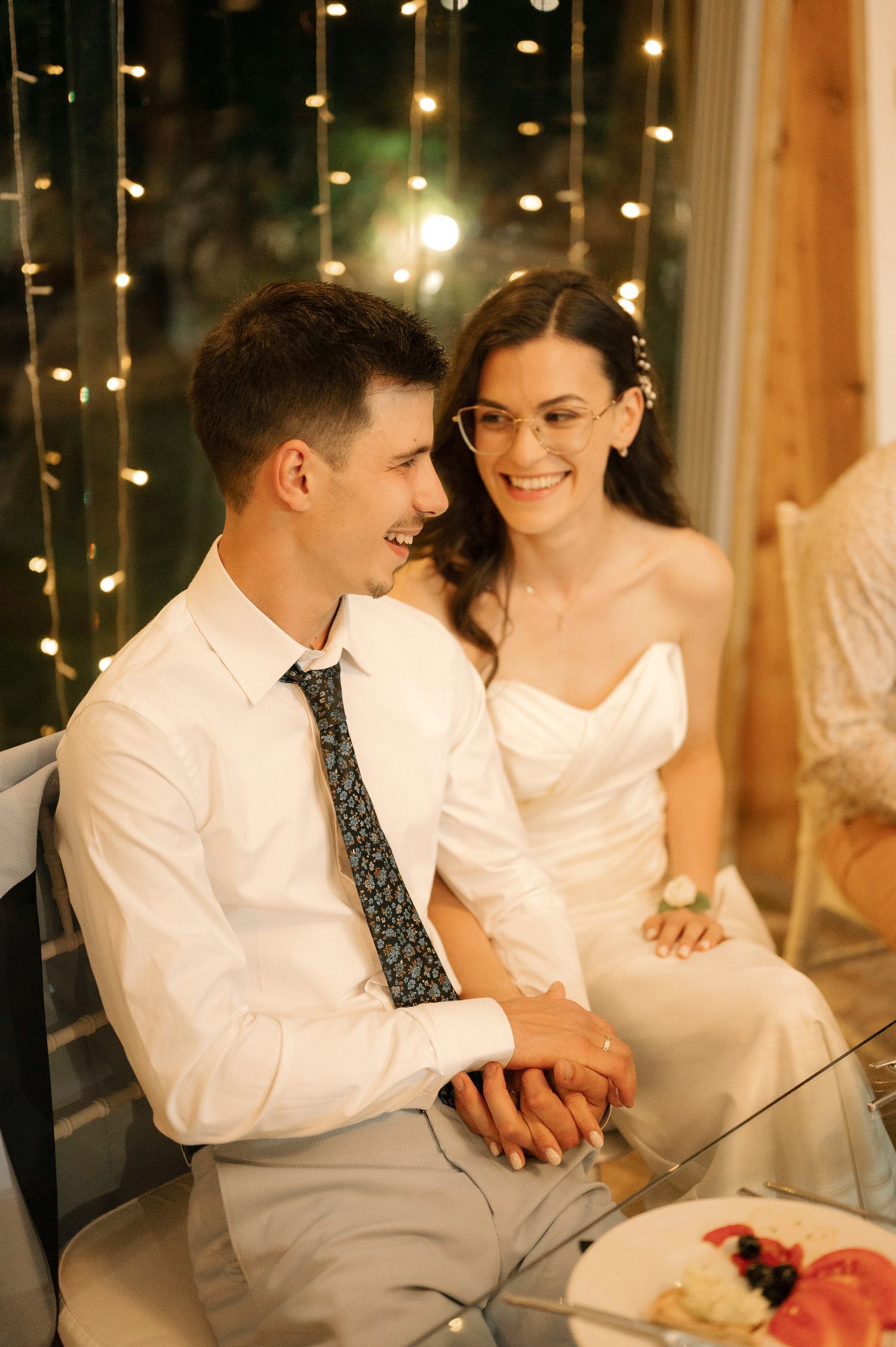 A couple shares an intimate moment at a candlelit table during a romantic evening celebration.