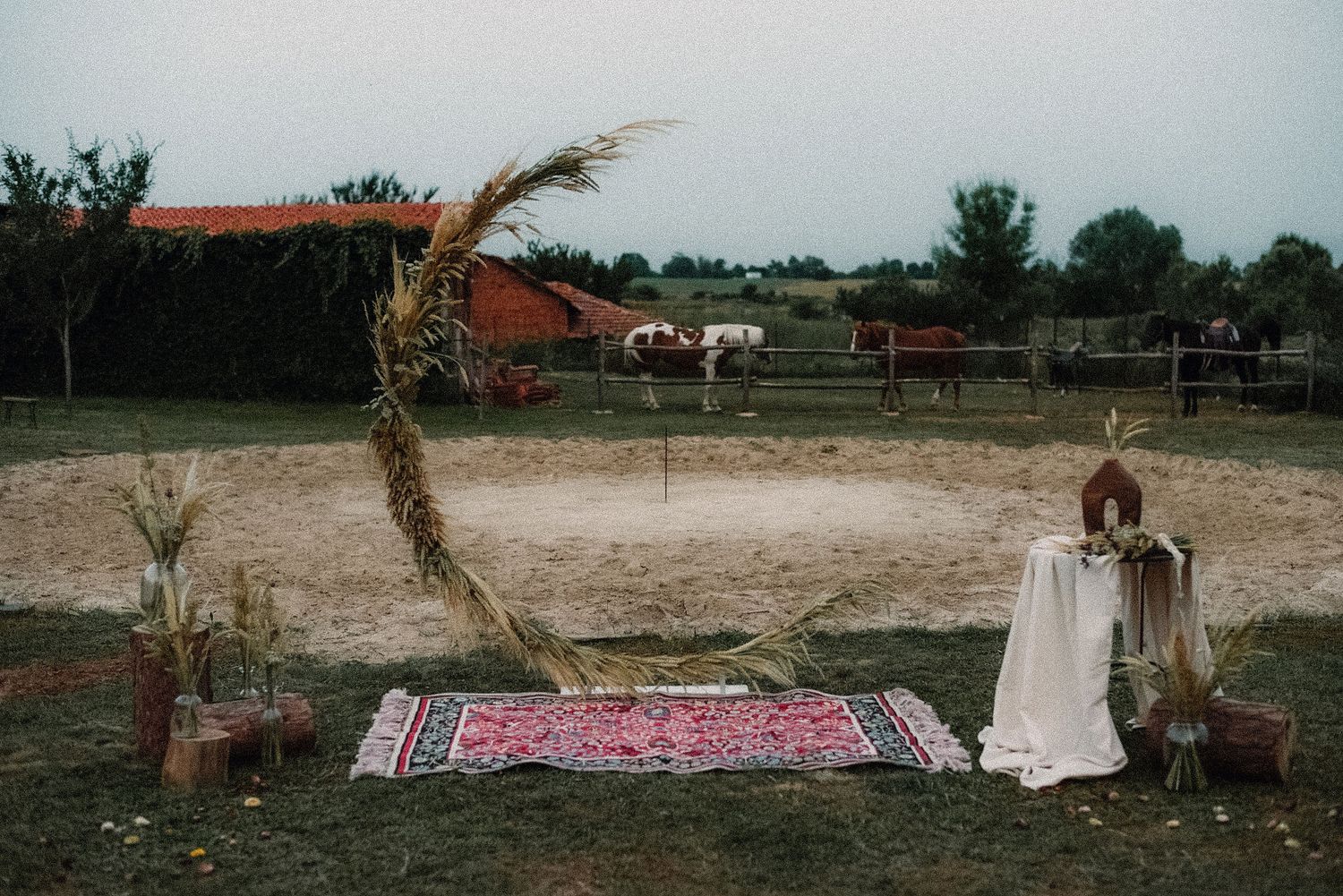 A series of rustic outdoor wedding ceremony setups with floral arrangements and seating areas in a natural setting.