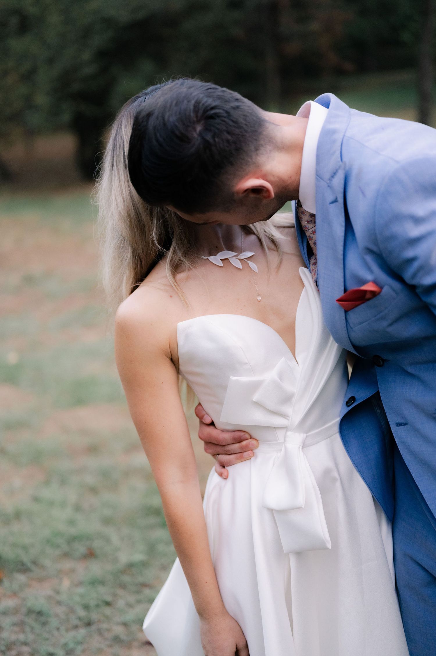 A romantic sequence of wedding photos showing a couple in white dress and blue suit embracing outdoors in a garden setting.