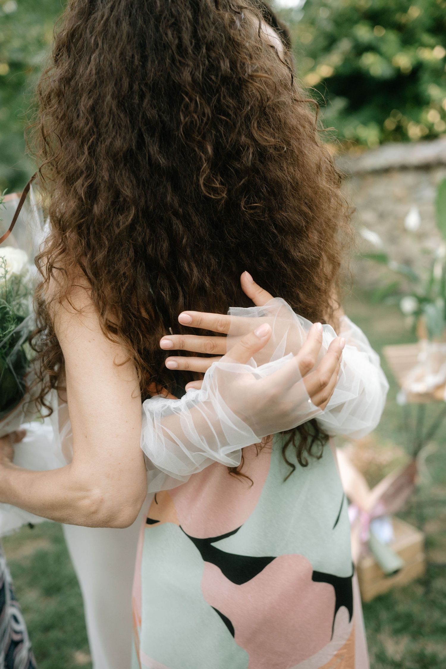 A series of photos showing curly hair being styled and arranged against a natural outdoor background.