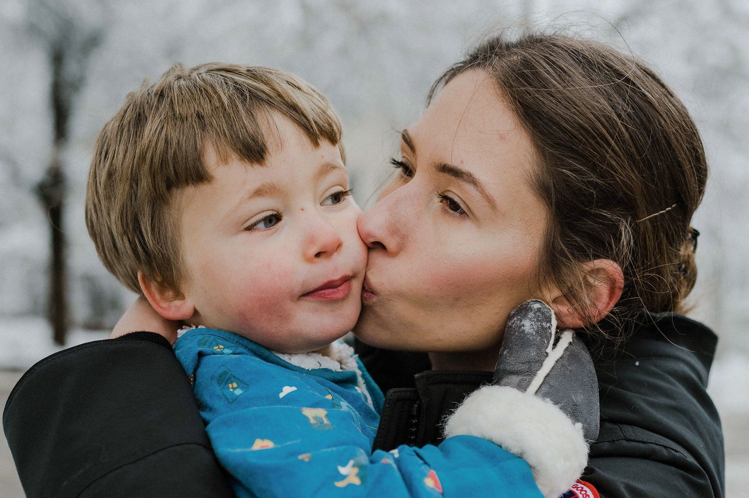 A parent and child share tender moments of affection and laughter in a series of connected photos.