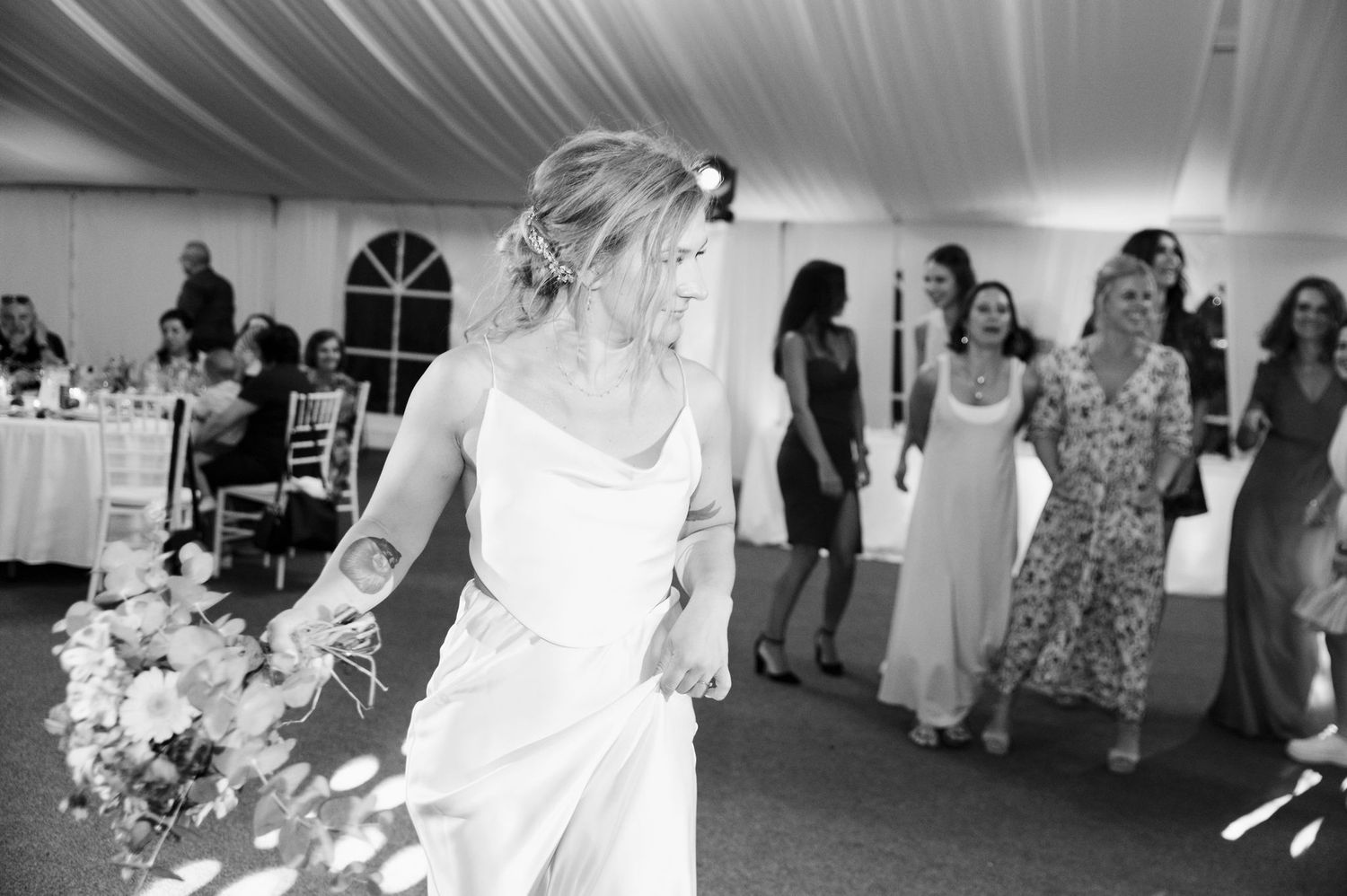 A sequence of wedding reception photos showing dancing, celebration and guests enjoying themselves at a white-themed venue.