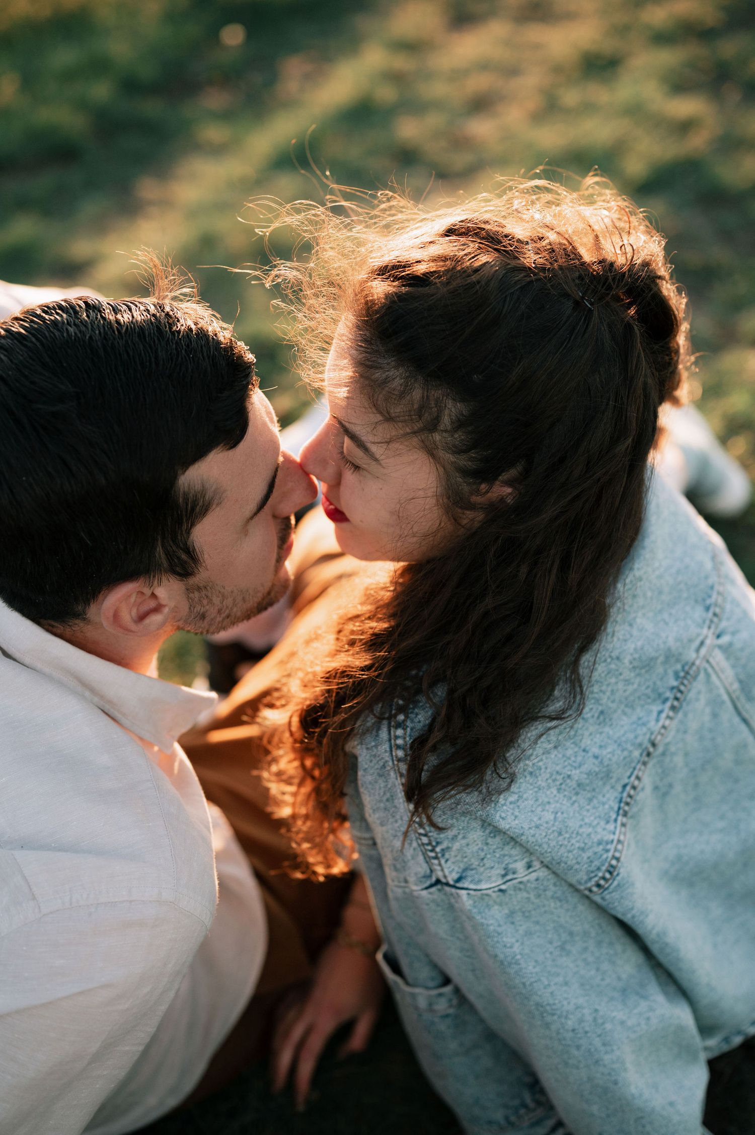 A romantic sequence of four photos showing a tender intimate moment between a couple in denim and white.
