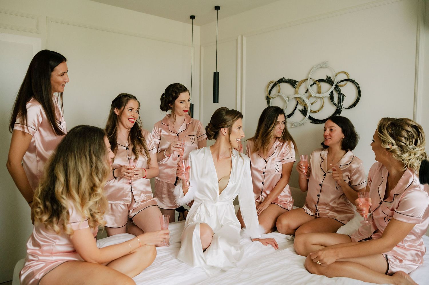 Group celebration in modern room with matching pink outfits.