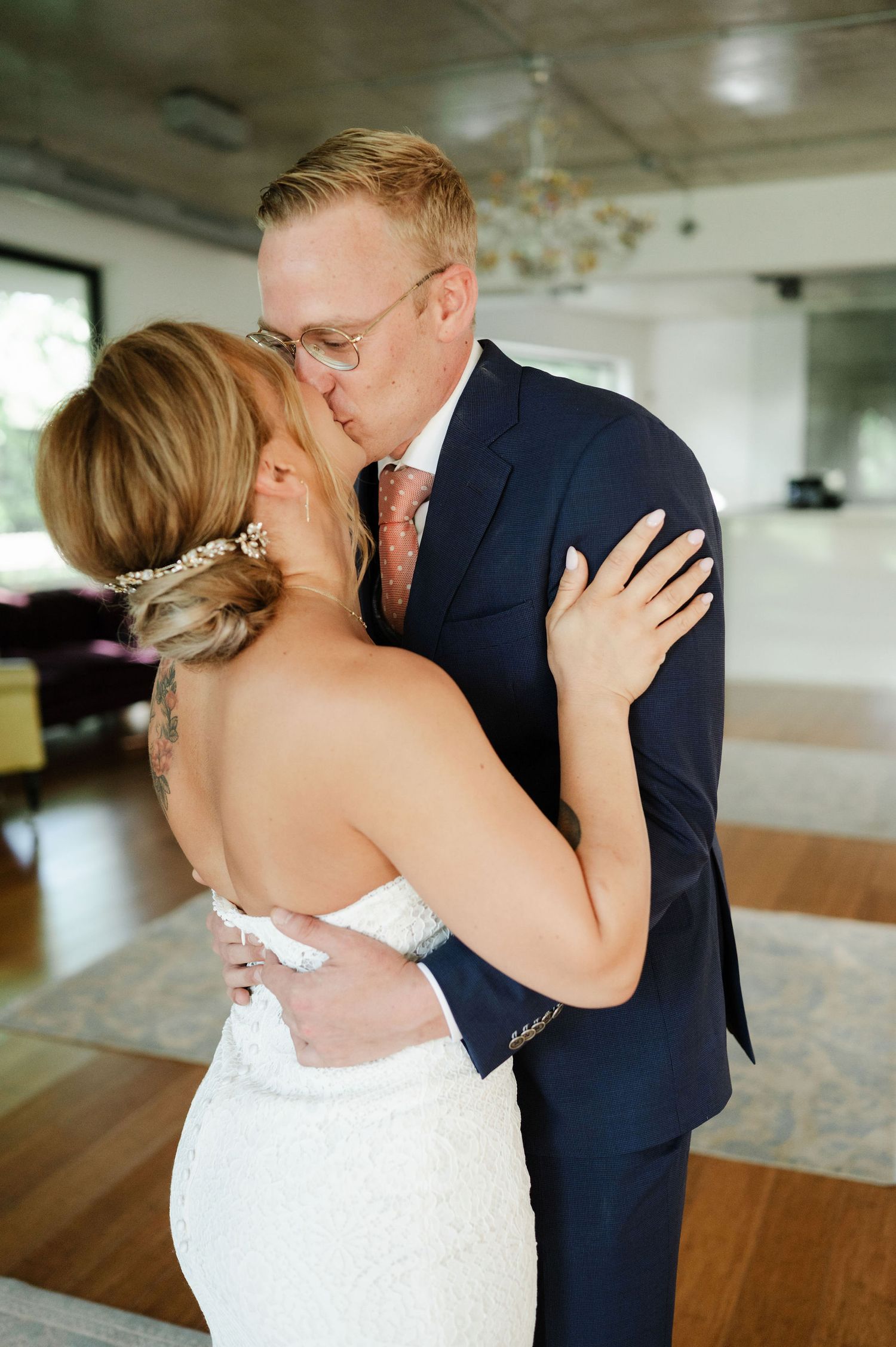 An intimate wedding moment captured during a first dance in a modern reception venue.