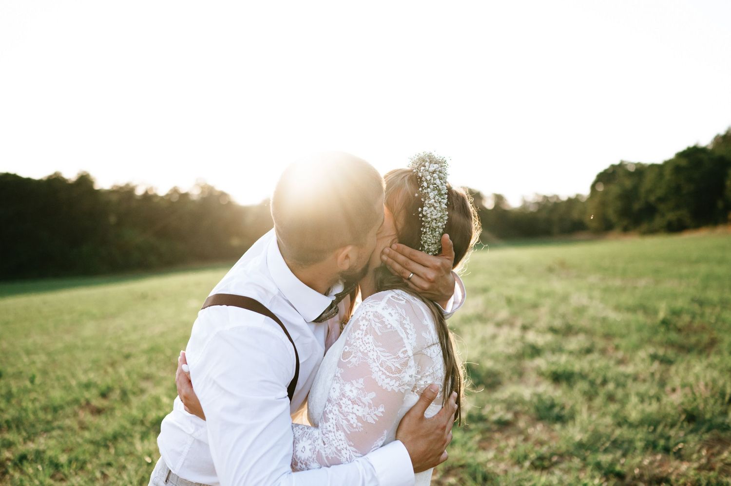 Couple shares tender moment during sunset wedding photography session.