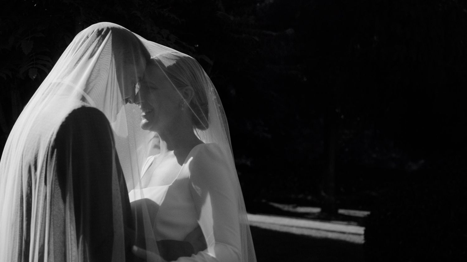 A collection of black and white wedding photos showing romantic moments between couples during their special day.