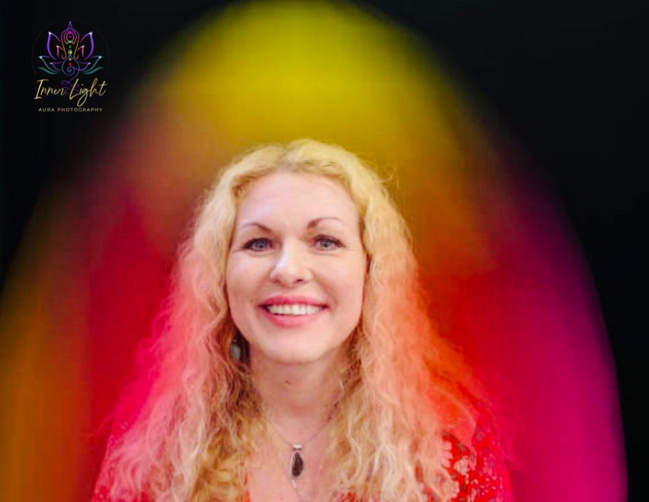 Aura photography portrait showing bright yellow, pink and red energy fields around a smiling woman, representing joy, love and confidence.