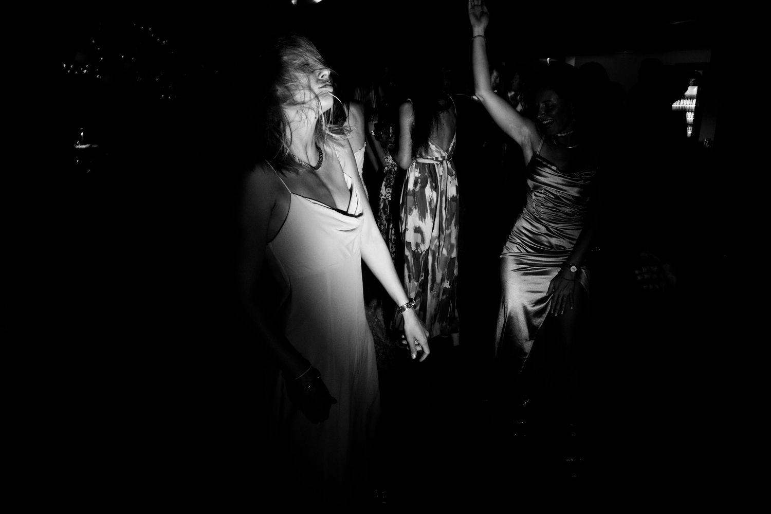 Dramatic black and white photos capturing dance movements in low light.