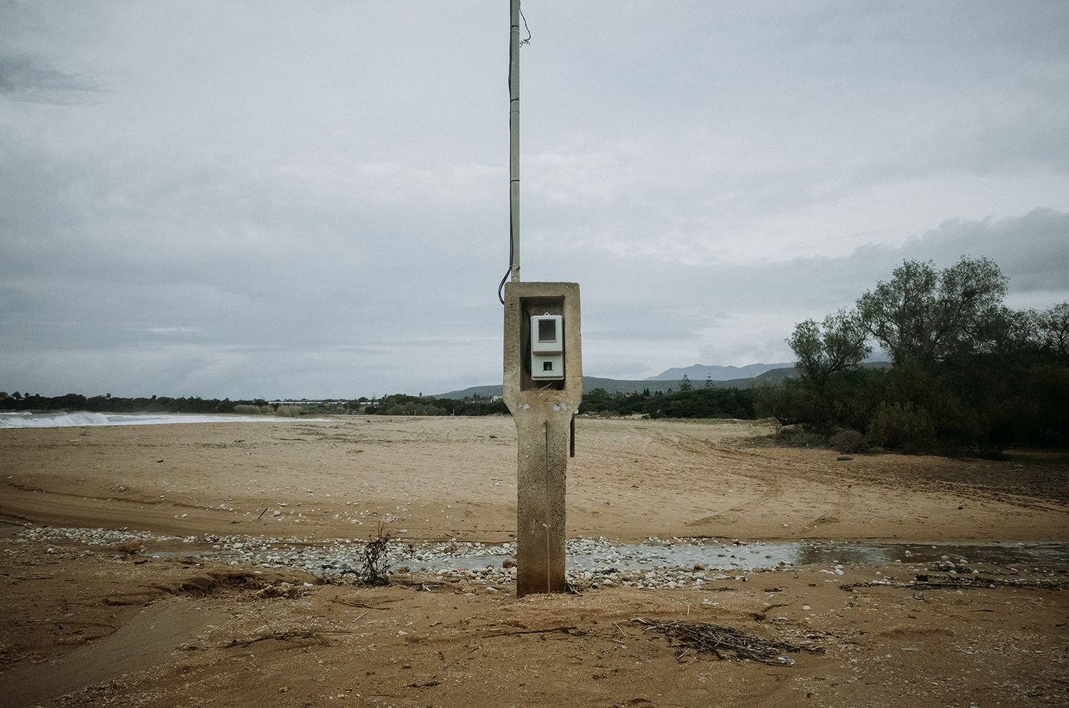 A series of panoramic landscape photos showing barren fields and scattered trees under an overcast sky.