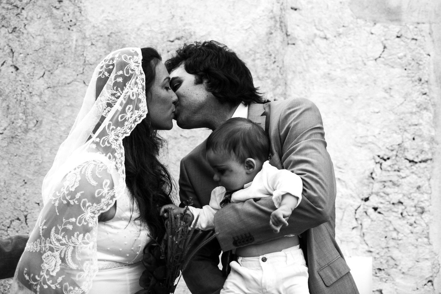 A romantic black and white wedding photo sequence showing tender moments between a couple.