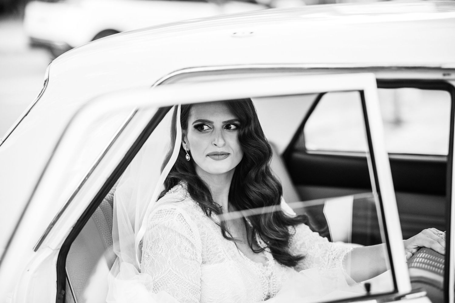 Classic black and white portraits taken through vintage car windows.