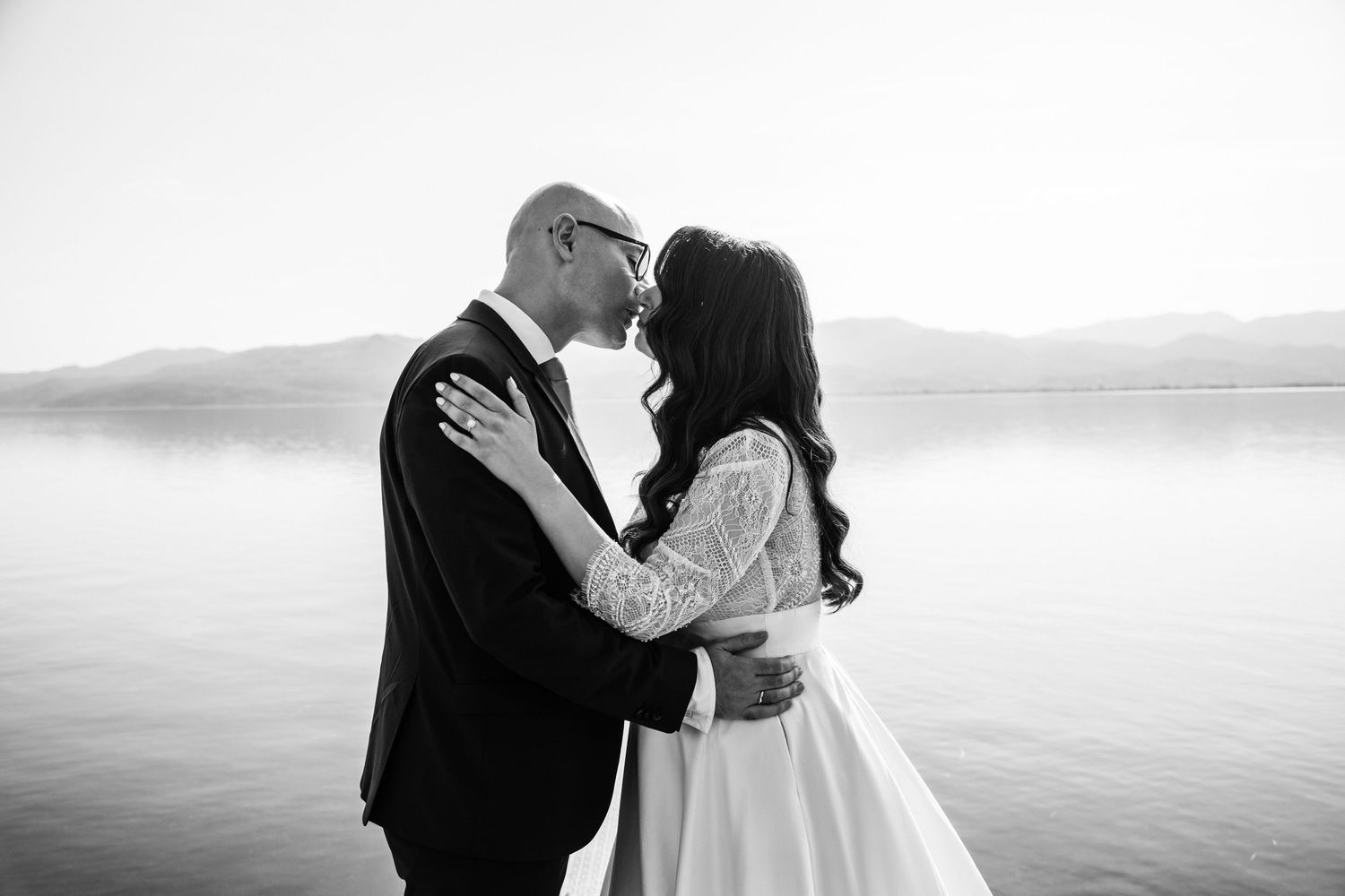 Romantic black and white seaside portraits capturing intimate wedding moments.