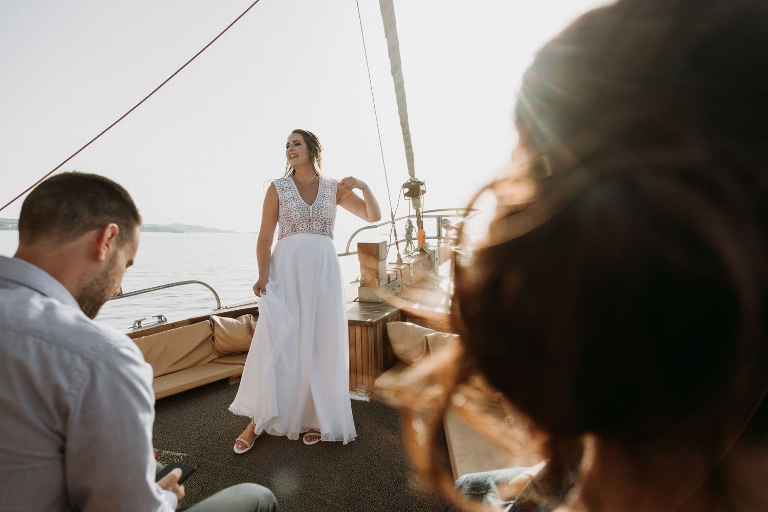 Seaside wedding photography sequence with natural sunlight and wooden elements.
