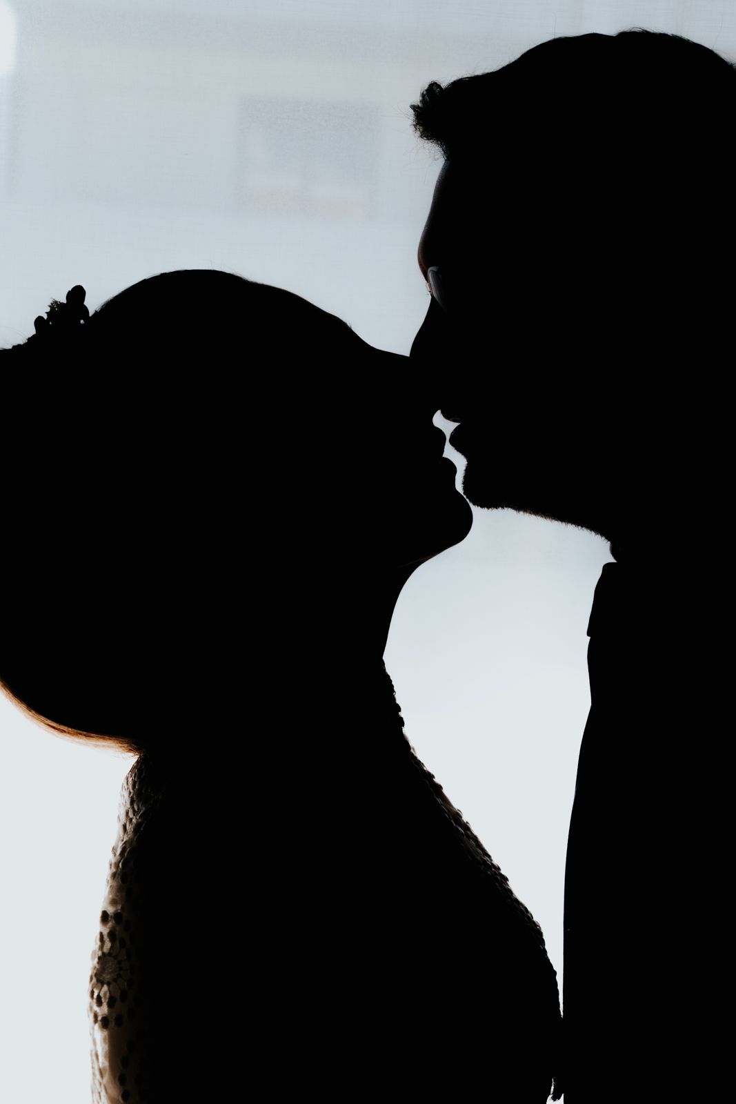 Silhouette series showing intimate moments between two people against a light background.