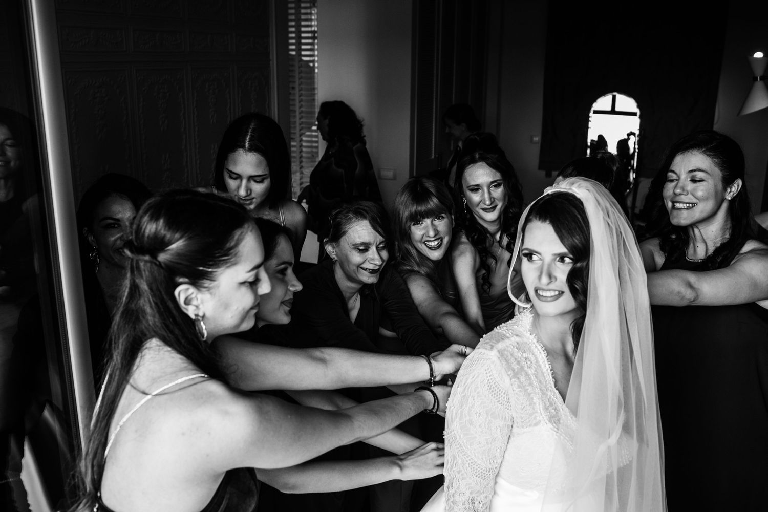 Black and white candid shots of wedding celebration with dancing and laughter.