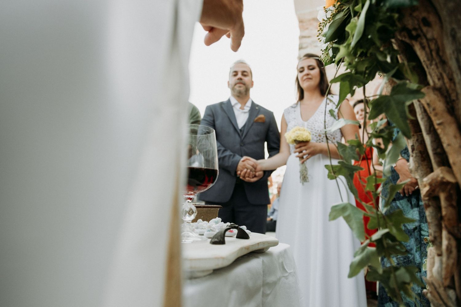 Intimate garden wedding reception with natural greenery and white decor elements.