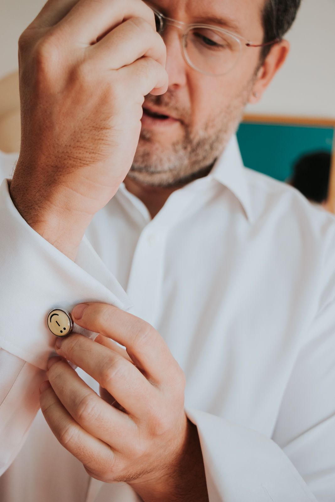 Close-up detail shots of hands and formal attire with a gold ring.