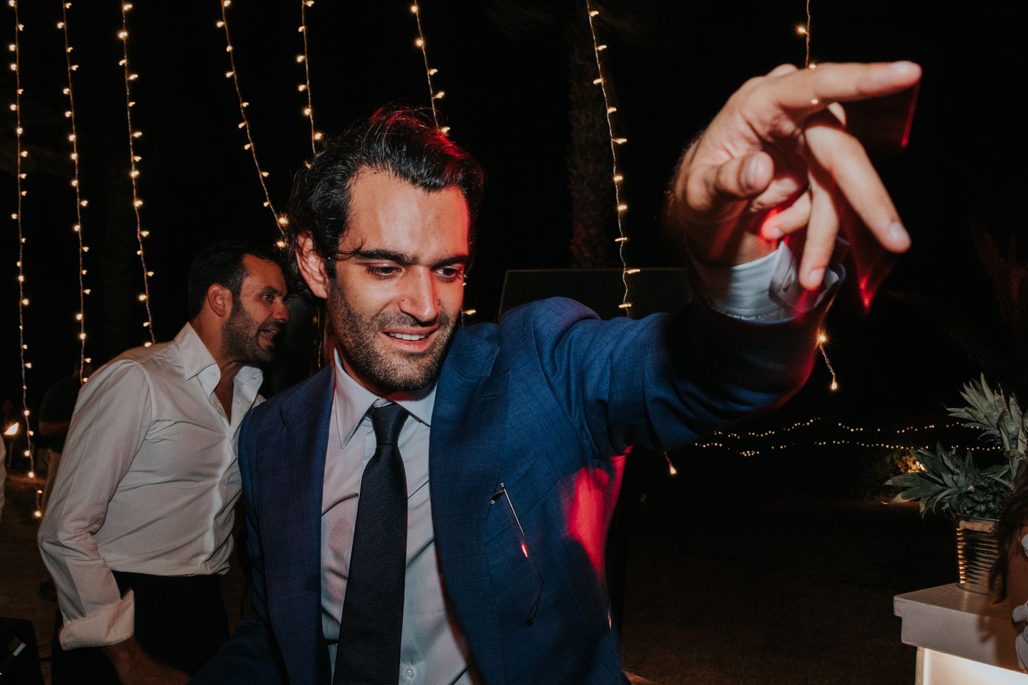 Lively dance party scene with string lights creating a festive atmosphere.