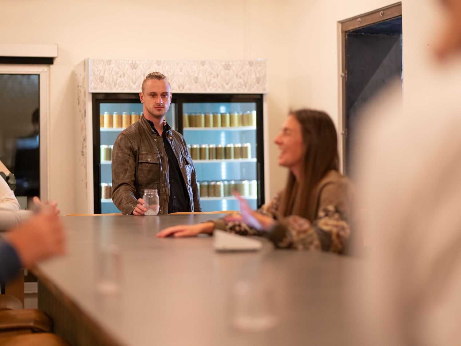 A series of connected office meeting room images showing people sitting at tables in a corporate environment.