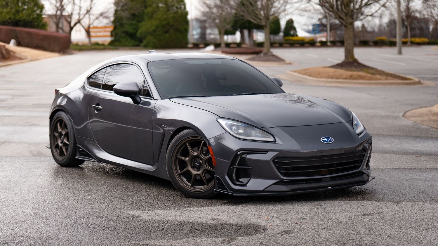 Wide angle shot of a slammed Subaru BRZ in matte gray finish.