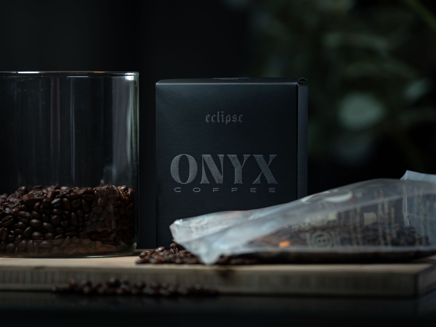 Onyx Coffee Lab Eclipse blend box displayed with coffee beans and glass jar on a wooden surface.