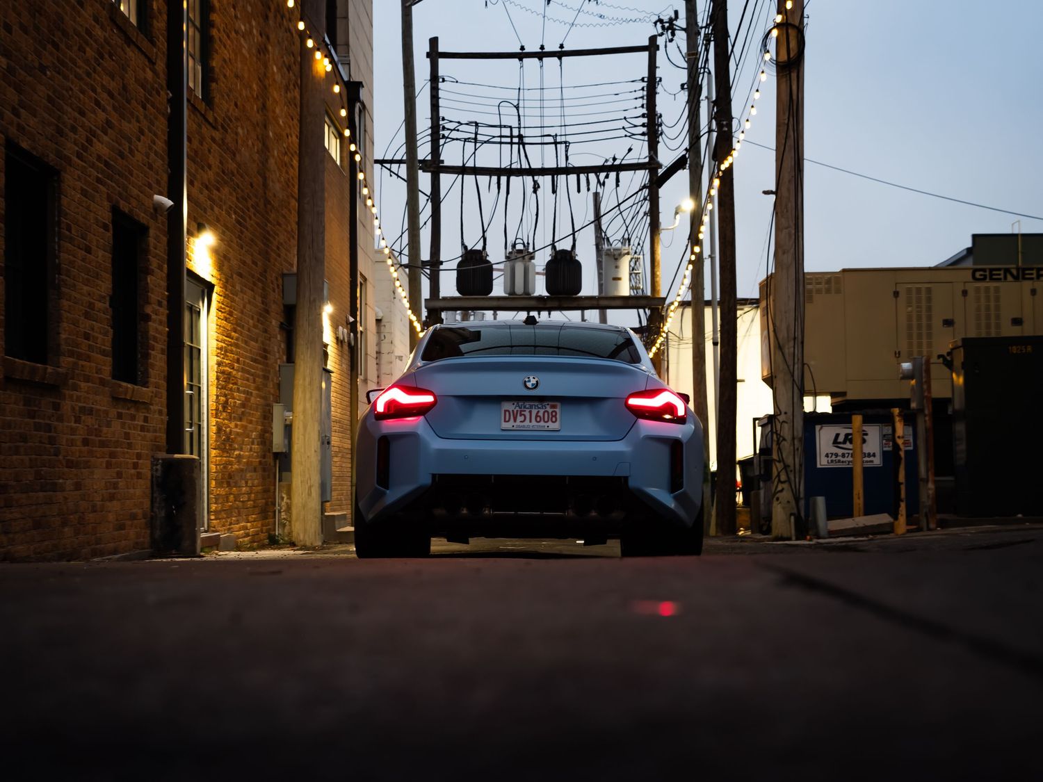 BMW M2 photographed in moody alleyway settings at dusk.