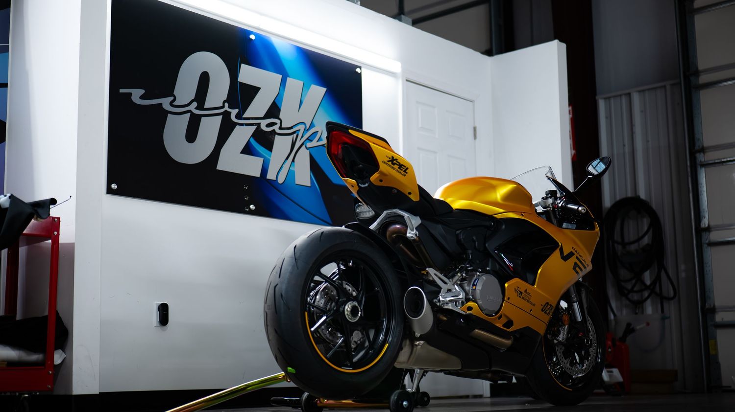 Wide angle view of a motorcycle showroom with custom bikes and branded signage.