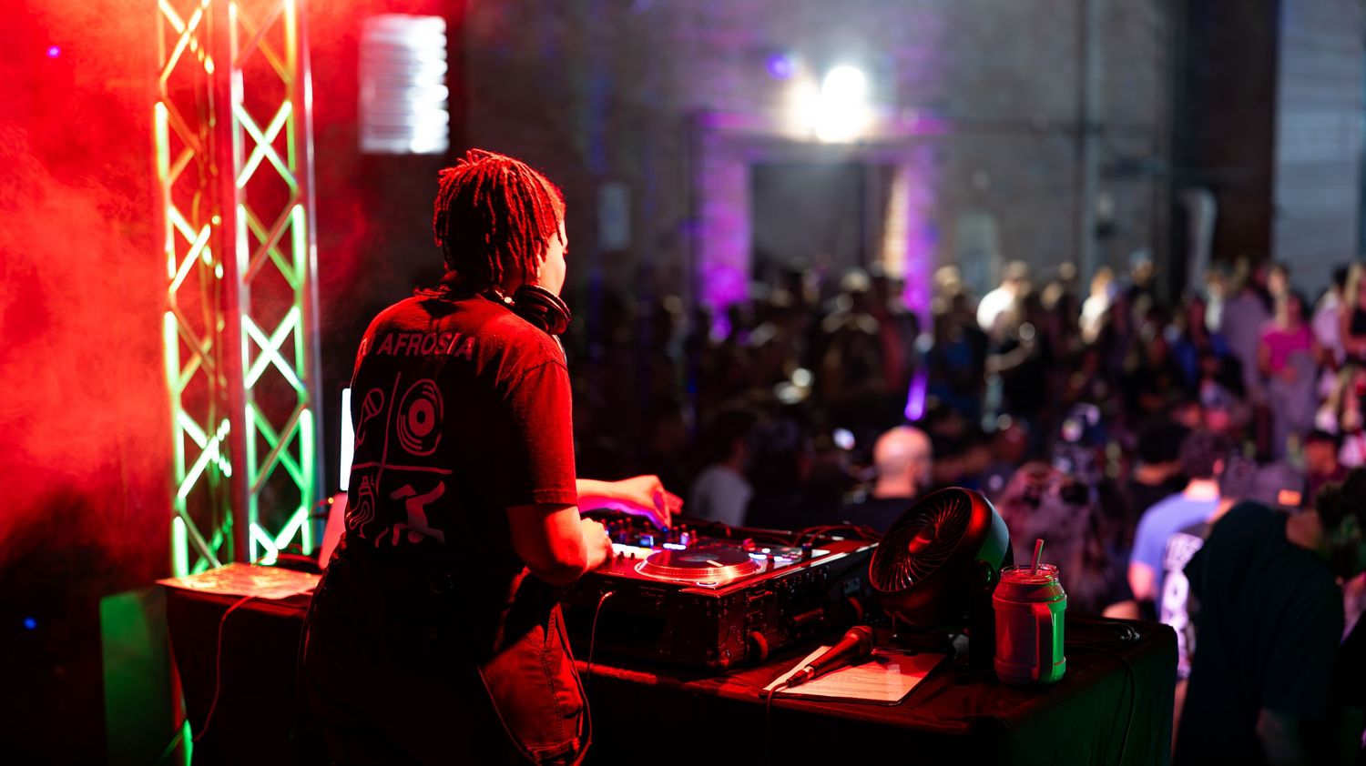 Stage lighting setup with red illumination at an indoor event.