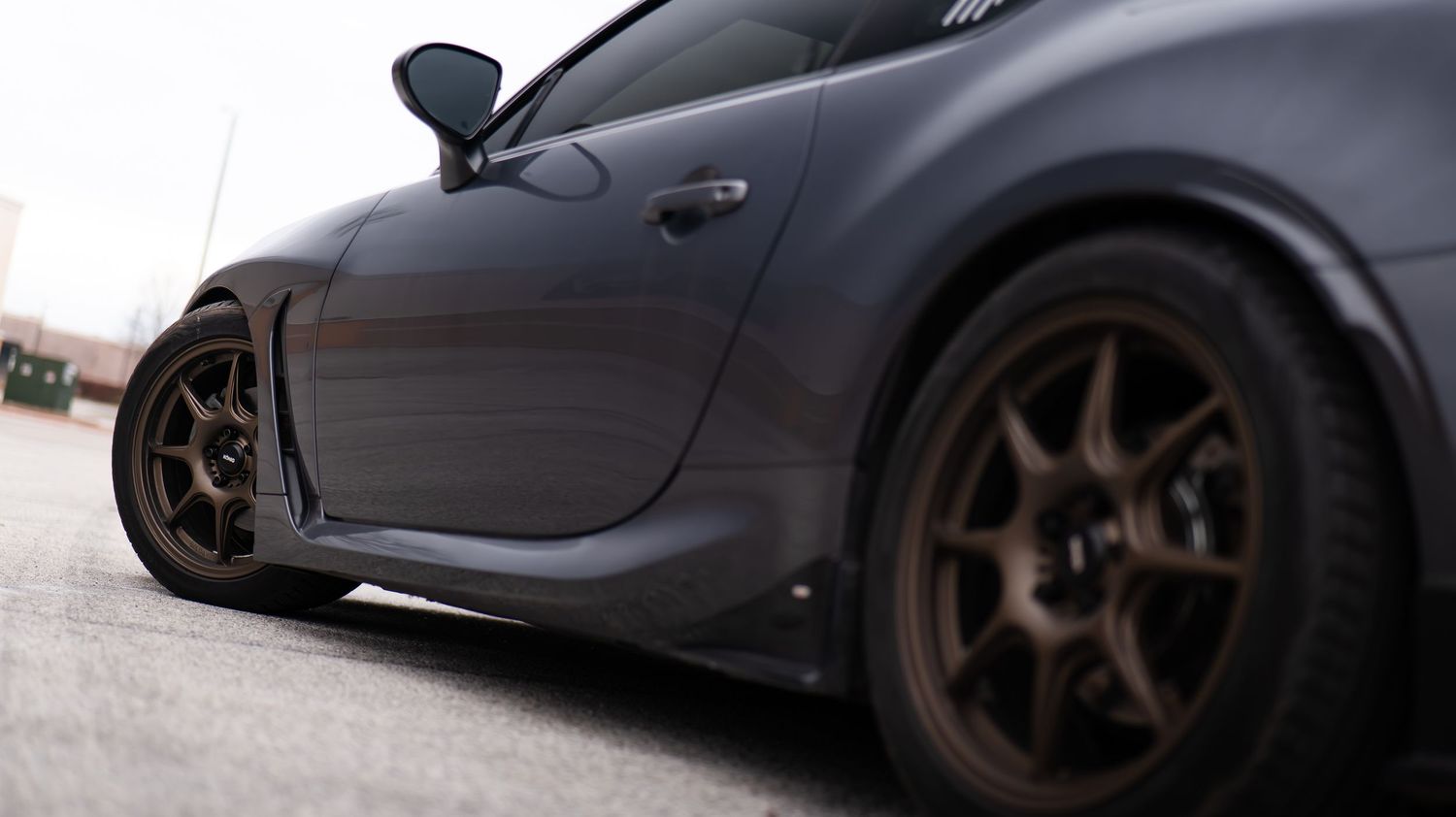 Low angle view of dark sports cars with sleek aerodynamic profiles.