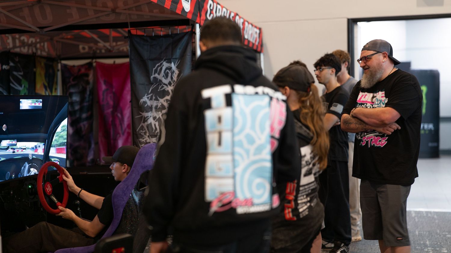 Indoor event space with Monster Energy branding and attendees.
