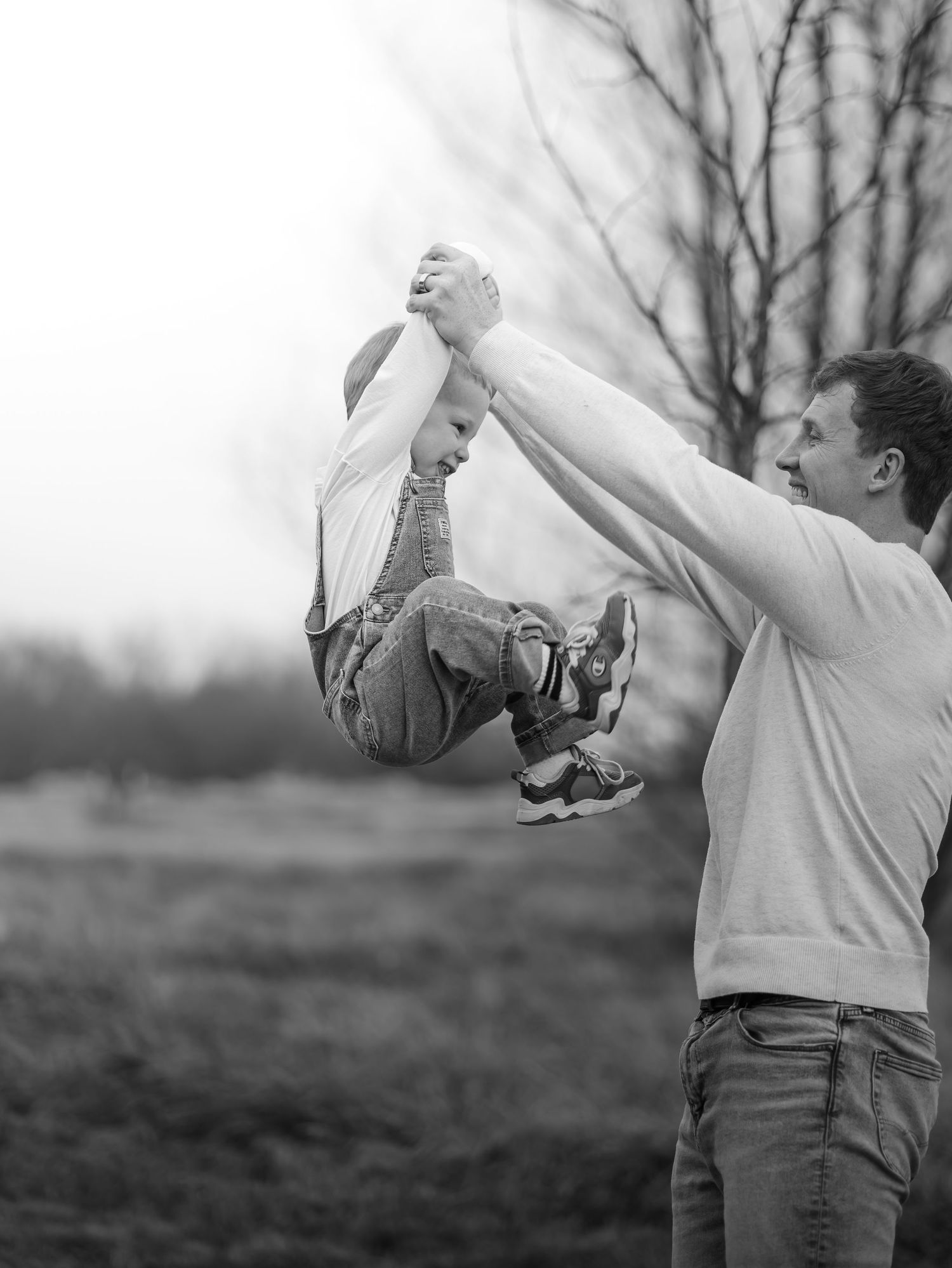 A sequence of black and white photos showing someone releasing a bird into flight from their hands.